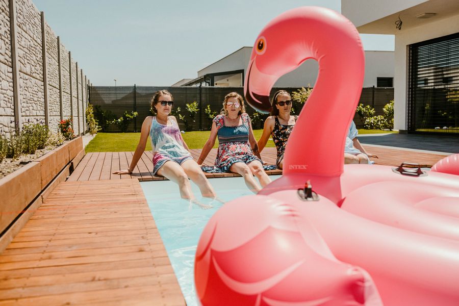 A flamingo float in a sunny swimming pool